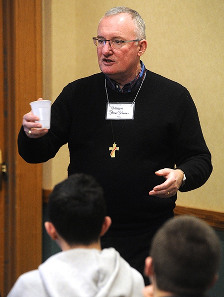 Deacon Steve Schumer speaks to students during the 